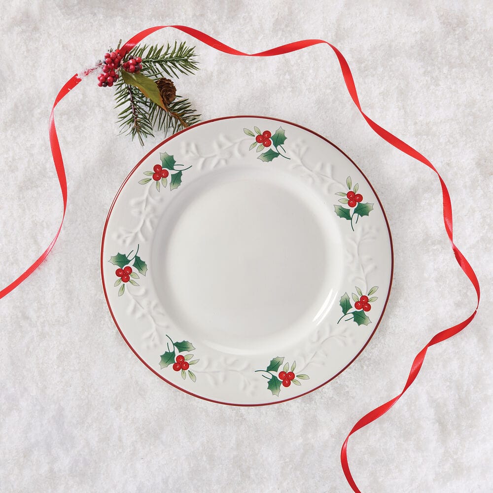 Winterberry Charm salad plate displayed on a textured surface with holly border and red ribbon
