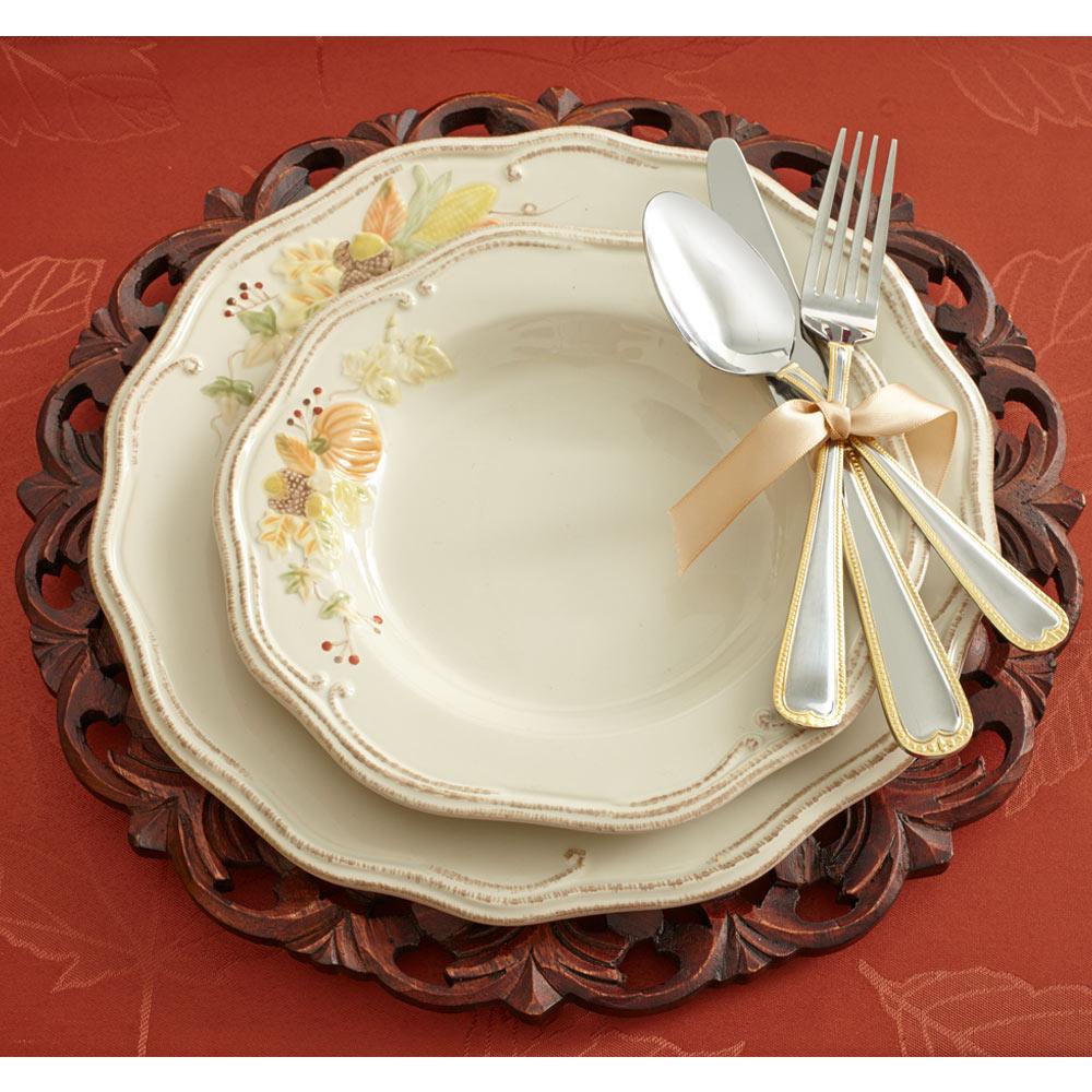 Plymouth dinner plate stacked on a carved wooden charger with a silverware bundle tied with a beige ribbon