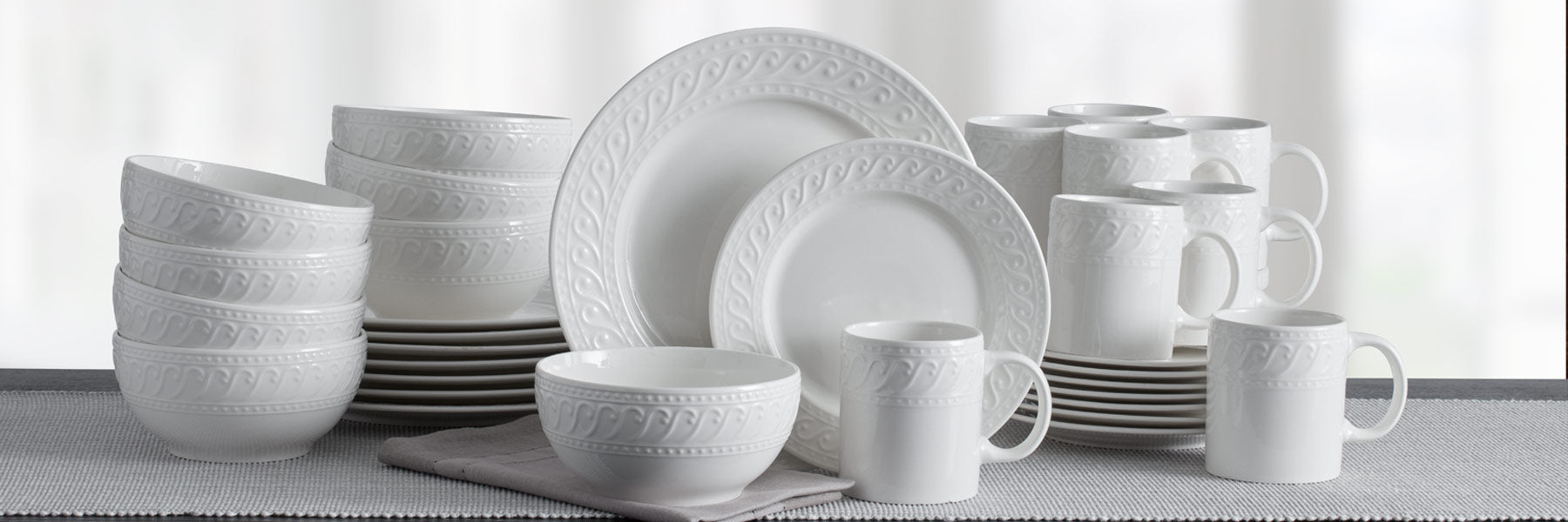 Sylvia brings simple elegance to the table with raised curls framed by beaded bands on clean white porcelain.