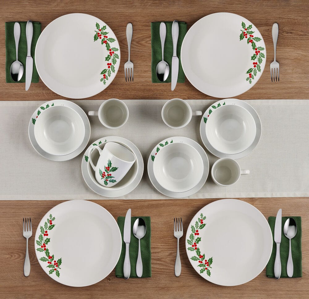 Holly Cheer 16 piece dinnerware set for four with white plates bowls mugs and cups featuring holly leaves and red berries.